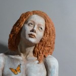 Sandy Frank sculpture red haired woman with monarch detail and poem Someone