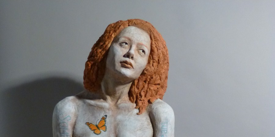 Sandy Frank sculpture red haired woman with monarch detail and poem Someone