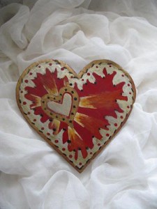 Heart trivet, red and silver resting in a cloud of white wedding veil